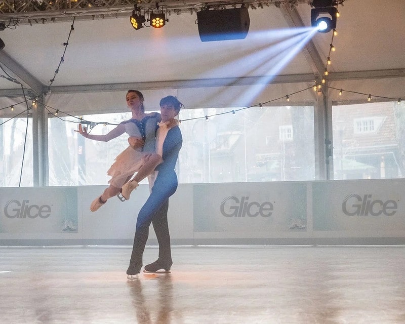 Couple figure skating on synthetic ice panels