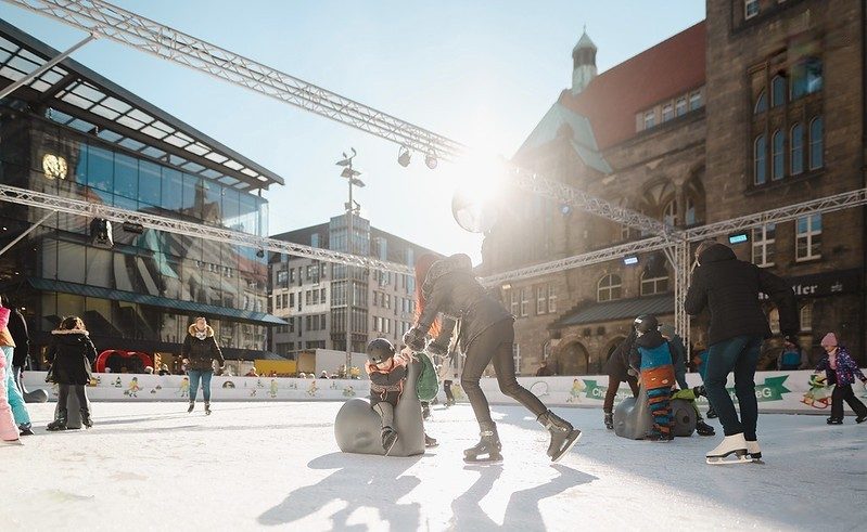 Ice rink with people ice skating outdoors