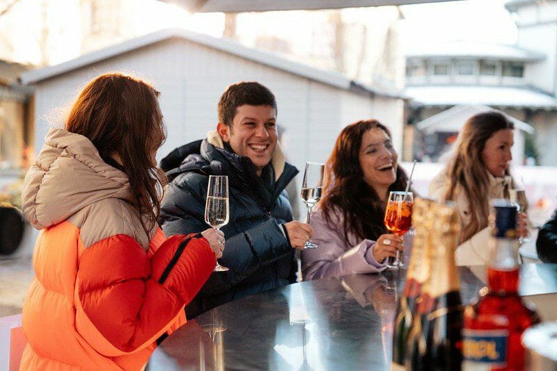 Friends enjoying drinks together while taking a break from skating