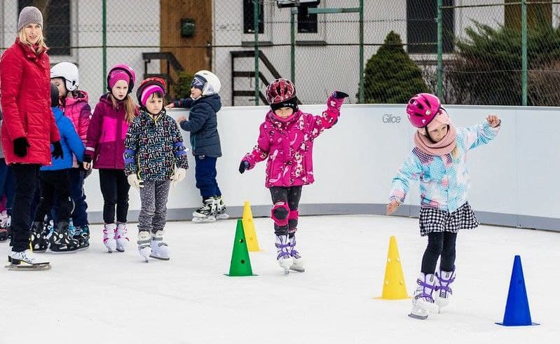 Kids learning how to ice skate on synthetic ice