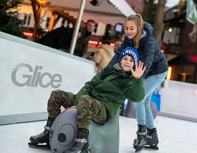 two kids with skating aid