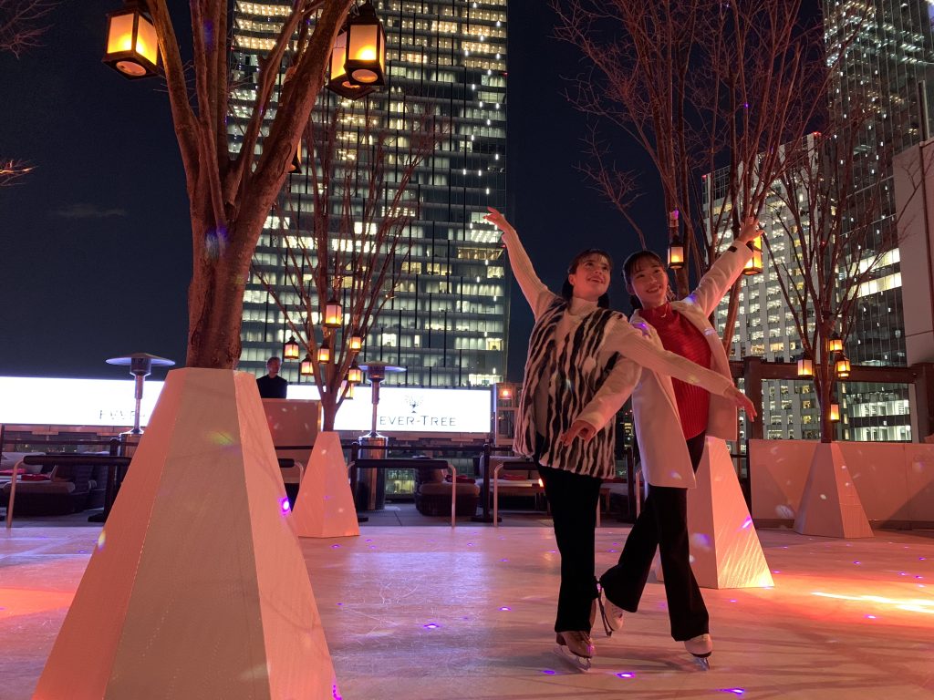 Two girls on Ce La Vi ice rink